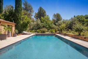 a swimming pool in a yard with trees at Villa Des oliviers in Le Beausset