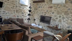a living room with a couch and a table at Thysanos in Ierápetra