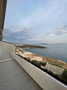 a balcony with a view of the water at Villa Besnik in Sarandë +44 photos