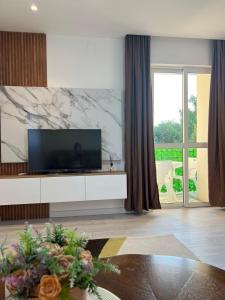 a living room with a flat screen tv on a white cabinet at Apartments Hillside in Ulcinj +97 photos