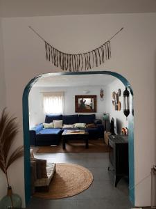 a living room with a blue couch and a table at Blue house Nature and calm in Tarifa