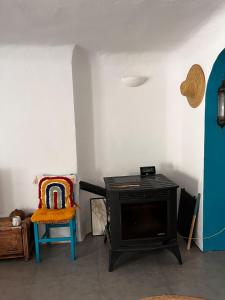 a living room with a stove and a chair at Blue house Nature and calm in Tarifa