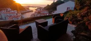 a view of a city from a hill at sunset at Apartamentos La Casa del Pintor in Cudillero