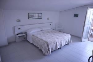 Postel nebo postele na pokoji v ubytování Hotel Astor