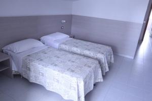 Postel nebo postele na pokoji v ubytování Hotel Astor