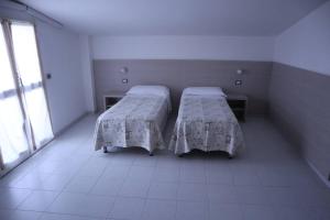 Postel nebo postele na pokoji v ubytování Hotel Astor