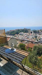 a table on a balcony with a view of a city at Monte View Apartments in Ulcinj
