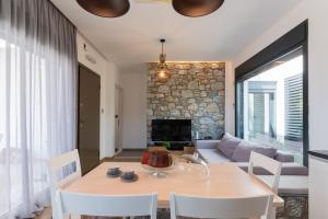 a living room with a table and a fireplace at Prasonisi Villas in Kattavía