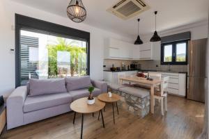 a living room with a couch and a table at Prasonisi Villas in Kattavía