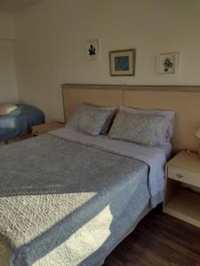 a bedroom with a bed with blue sheets and pillows at Departamento Corrientes Av. in Buenos Aires