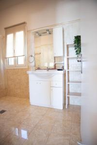 a bathroom with a sink and a mirror at Endless Seaview Villa in Argostoli +42 photos