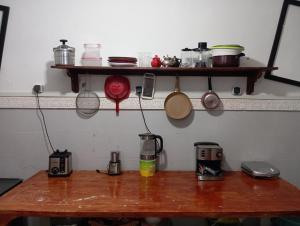 a wooden table with pots and pans on a shelf at Medina Appartement With Shared Terrace in Marrakech