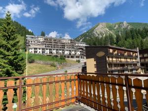 a balcony with a view of a building and a mountain at Piccolo Rifugio di Foppolo in Foppolo