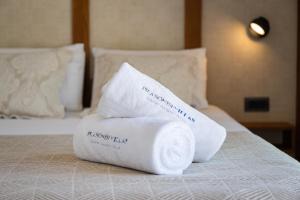 a pile of towels sitting on top of a bed at Prasonisi Villas in Kattavía