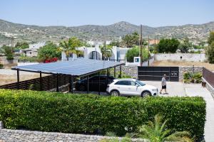 a car parked in a parking lot with a solarium at Prasonisi Villas in Kattavía