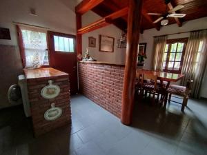 a living room with a fireplace and a dining room at Casa Santa Elena in Malargüe