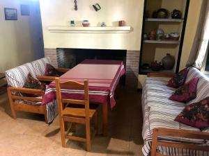 a dining room with a table and a fireplace at Puerto los Pinos in Cortegana