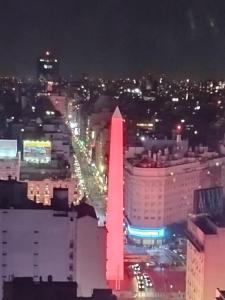 a view of a lit up city at night at Depto torre Bayres Obelisco in Buenos Aires