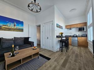 a living room with a couch and a table at The Nest in Weymouth in Weymouth