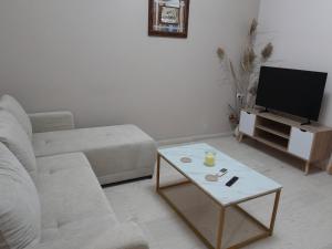 a living room with a couch and a coffee table at Ioli's apartment in Igoumenitsa