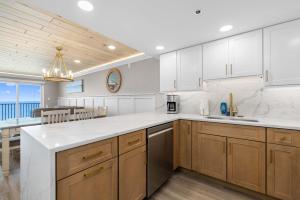 a kitchen with white countertops and a dining room at Spectacular Oceanfront Penthouse - Unit 1203 in Ocean City