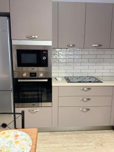 a kitchen with a stove and a microwave at Anna's House in Kos +92 photos