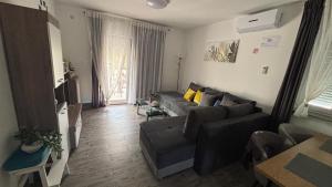 a living room with a couch and a tv at Apartmani Mirela in Krk