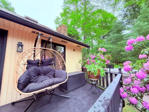 a large pillow sitting on the back of a porch at Bethel Escape Hot Tub 4 beds Game Room and Fire pit Fully Stocked Kitchen in Smallwood