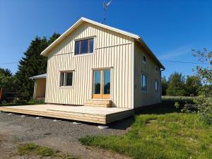 a small house sitting on a wooden deck at Rural charm & modern comfort 