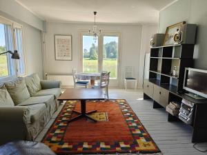 a living room with a couch and a table at Rural charm & modern comfort 