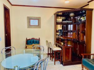 a dining room with a glass table and chairs at El Barco Colonial in Quito