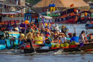 a group of people on boats in the water at Lam NguyenVn Minihouse in Can Tho
