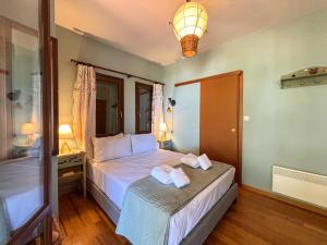 a bedroom with a bed with two towels on it at Duchess Eva's Seafront Guesthouse in Chorefto +46 photos
