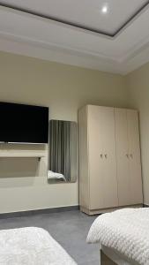 a bedroom with a tv and a bed and a tvictericter at استديو جديد in Hail
