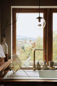 a kitchen sink with a window and a book on it at SUNCHILL luxury treehouse in Saint-Antonin