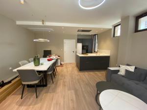 a living room and kitchen with a couch and a table at Luxurious house Sarafovo beach in Burgas City