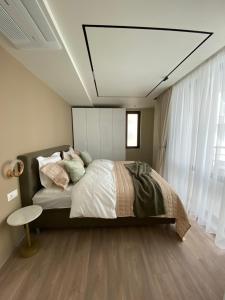 a bedroom with a large bed and a large window at Luxurious house Sarafovo beach in Burgas City +21 photos