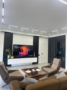 a living room with a flat screen tv on a wall at Luxury Residence in Mirabad Avenue in Toshkent-Passajir Bekati