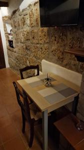a wooden table with two chairs and a table and a table at IL NIDO di PITIGLIANO in Pitigliano +5 photos
