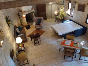 an overhead view of a living room with a bed and chairs at Chaumière en Brenne in Mauvières