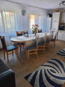 a kitchen and dining room with a table and chairs at CASA LAVINIA CRASNA GORJ in Crasna