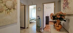 a hallway with a vase with flowers in it at Giardino D'amore By Belcanto Villas in Piano di Mommio +58 photos