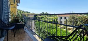 a balcony with chairs and a view of a yard at Giardino D'amore By Belcanto Villas in Piano di Mommio
