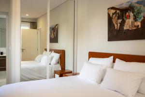 a bedroom with two beds and a mirror at Villa Julieta in Ferreiros de Avões +91 photos