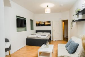 a bedroom with a bed and a living room at DP Homes in Lübeck
