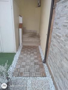 a hallway with a brick floor and stairs at Mazzeo in Santa Maria di Castellabate