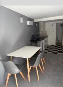 a table and chairs in a room with a kitchen at Hidden Putney-Studio Flat in London +2 photos