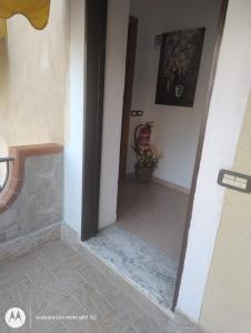 a hallway of a house with a door open at Mazzeo in Santa Maria di Castellabate