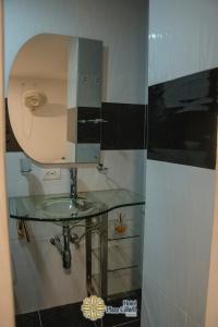 a bathroom with a glass sink and a mirror at Hotel Plaza Centro Cocorná in Cocorná