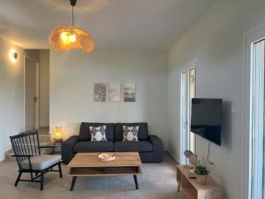 a living room with a couch and a table at Villa Eleni Aegina in Egina
